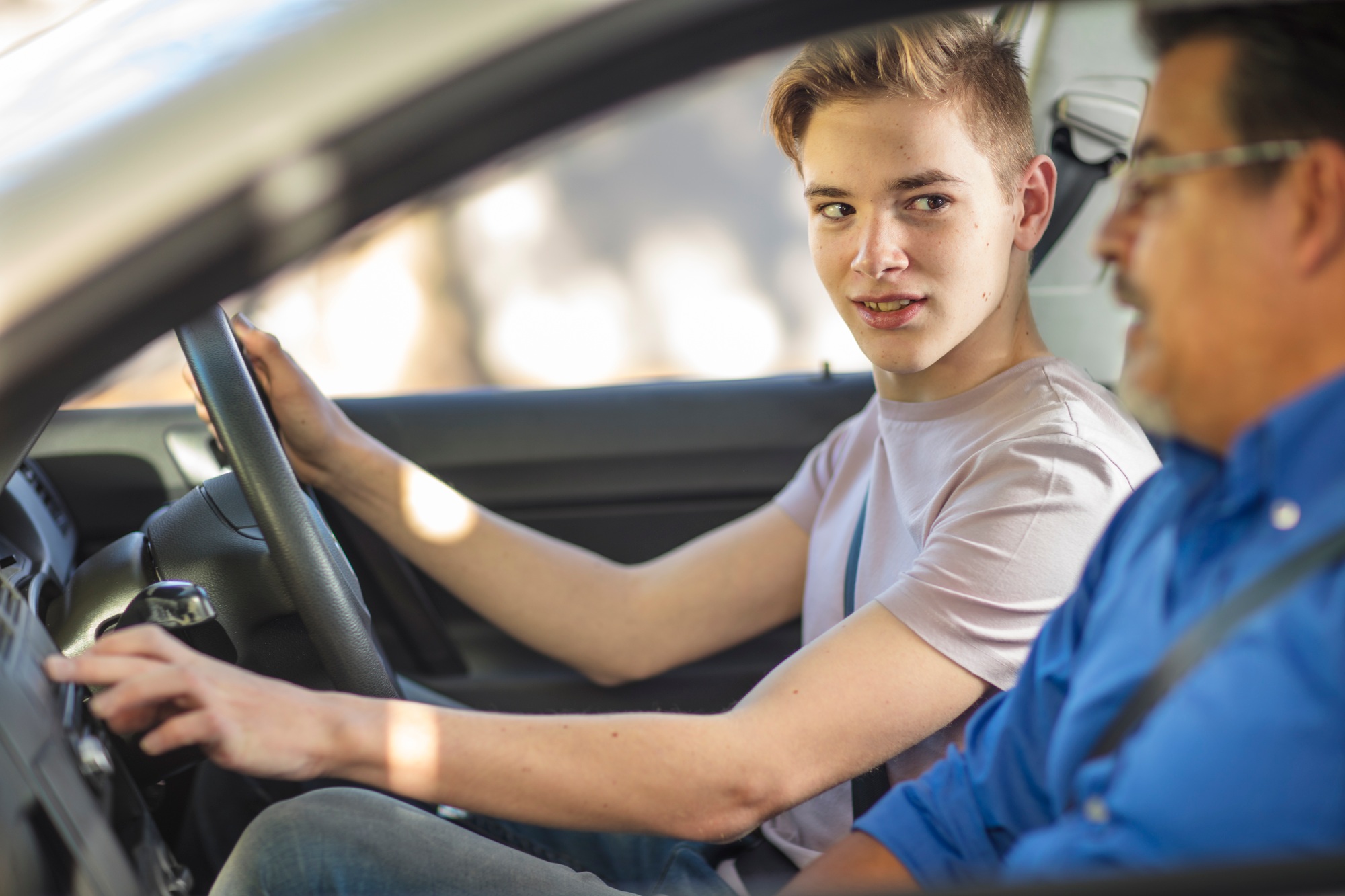 Learner driver with instructor in car